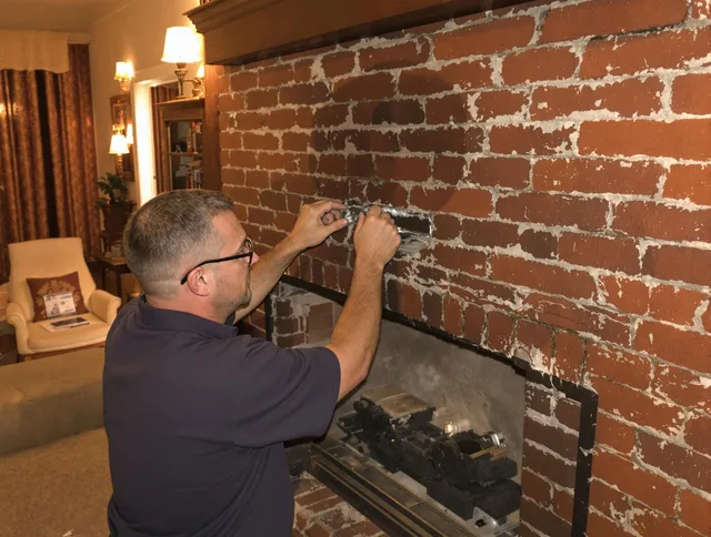 East Cleveland Chimney Sweep expert fixing a fireplace in East Cleveland, OH